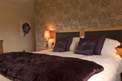 purple-bedroom-whitefalls-spa-lodges1